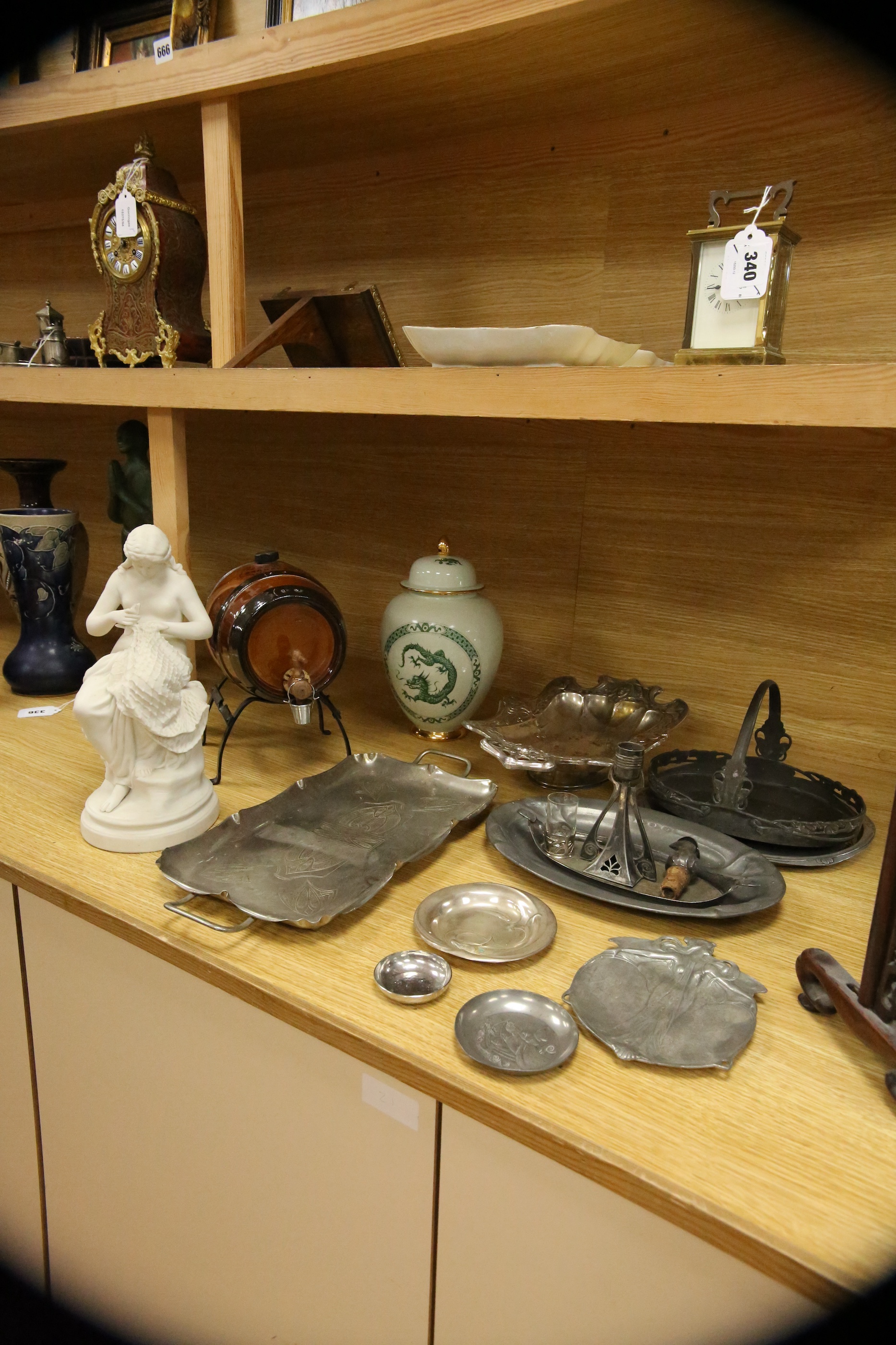 A Parian porcelain figure of a girl mending a fishing net, a Carltonware jar and cover, a “Pedestrian Barrelette” on stand and thirteen various Art Nouveau metal trays, dishes and candlestick including WMF etc, largest t